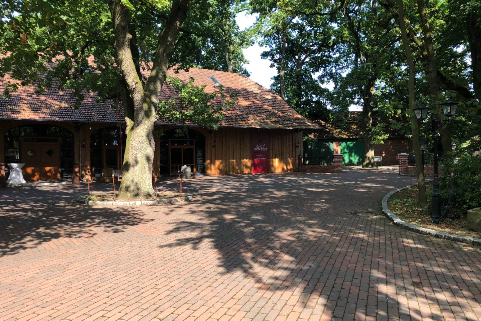 Das Gebäude vom Hof Frien in Uchtemit einem Baum vor dem Gebäude